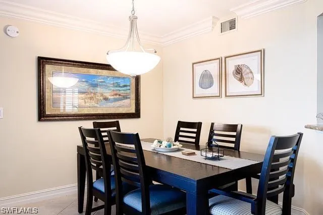 Dining space featuring crown molding and baseboards