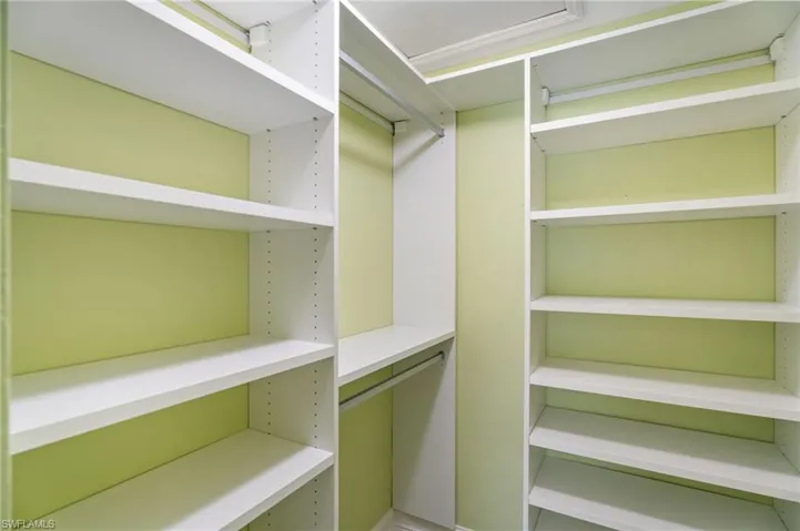 Bedroom/office with walk-in California Closet shelving.