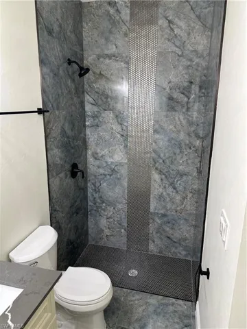 Bathroom featuring a shower stall and vanity