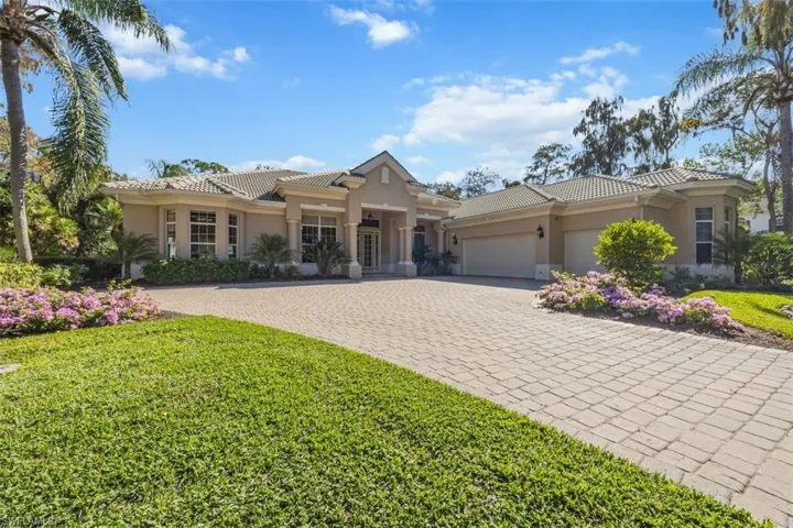 Mediterranean / spanish-style home featuring stucco siding, a tile roof, decorative driveway, and a garage