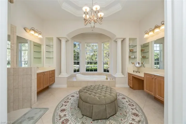 Full bathroom with a bath, healthy amount of natural light, built in shelves, and ornamental molding