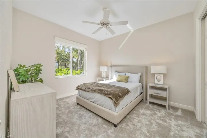 Carpeted bedroom featuring baseboards and a ceiling fan