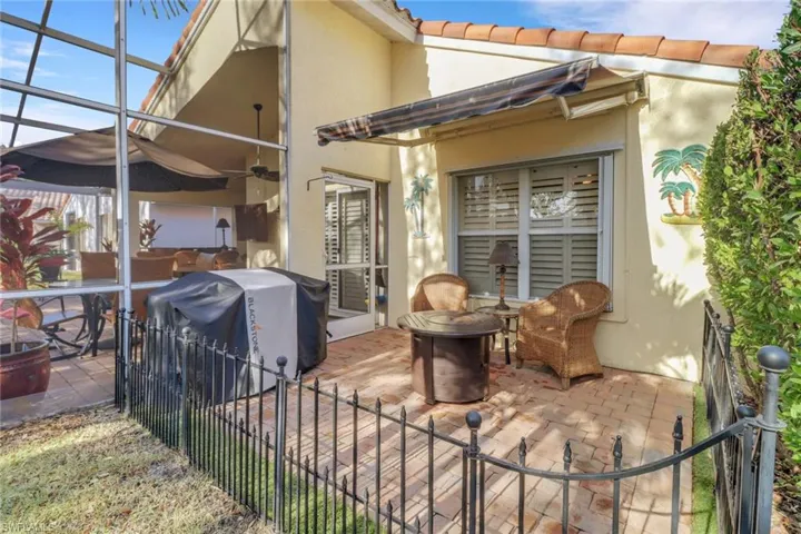 View of patio / terrace featuring grilling area, glass enclosure, and ceiling fan