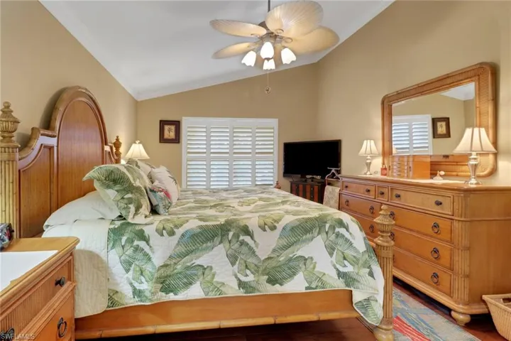 Bedroom featuring ceiling fan, vaulted ceiling, and ornamental molding