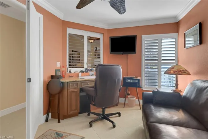 Home office featuring light tile patterned floors and ornamental molding