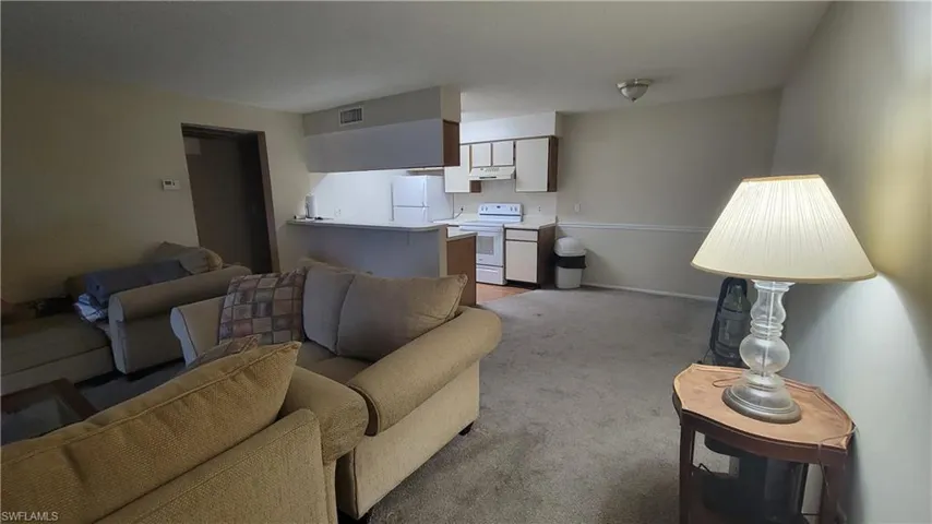 Living room featuring light colored carpet