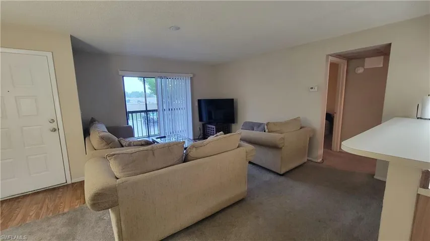 Living room featuring dark hardwood / wood-style flooring