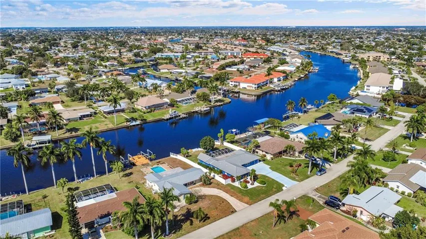 Aerial perspective of a waterfront residential area featuring numerous canal-front homes