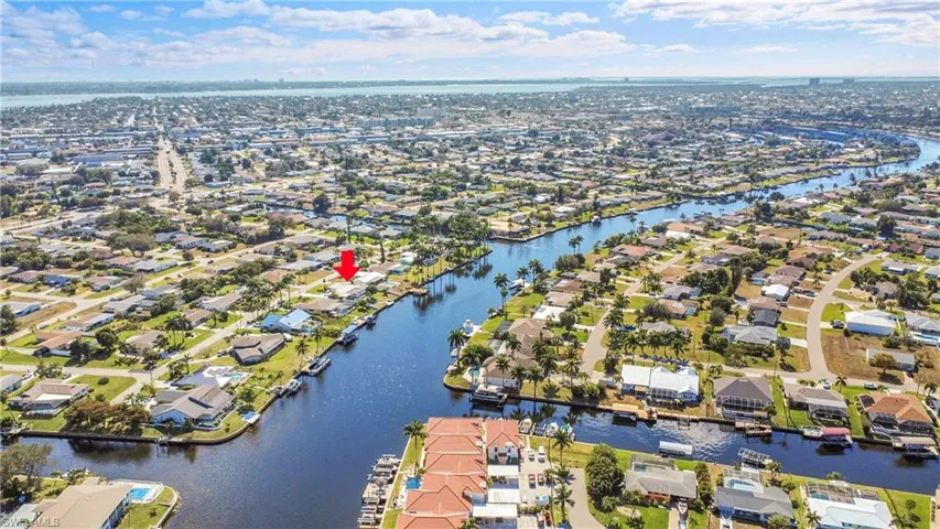 Waterfront property featuring canal access, dock space, and a waterfront yard