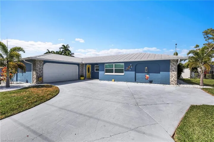 Exterior featuring a metal roof, stone accents, and a vibrant blue facade