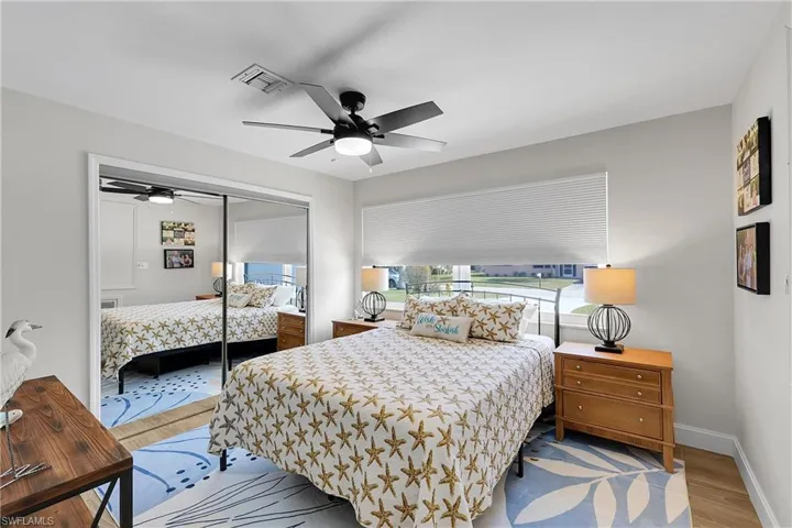 Bedroom featuring light wood-finish flooring and a ceiling fan with integrated lighting