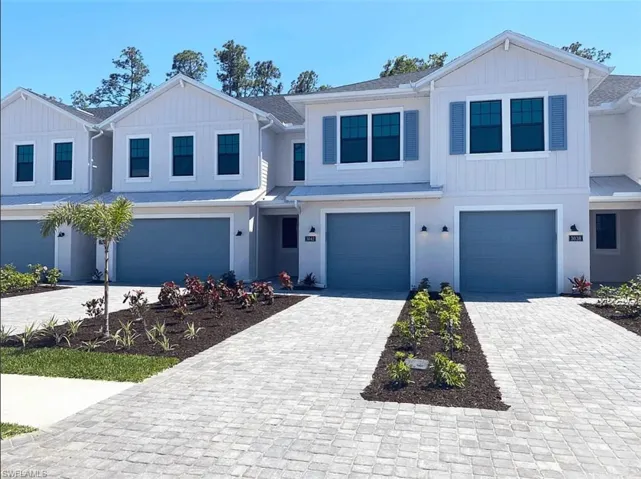 Model Home Virtually staged Craftsman-style home featuring decorative driveway, an attached garage, a metal roof, and a standing seam roof
