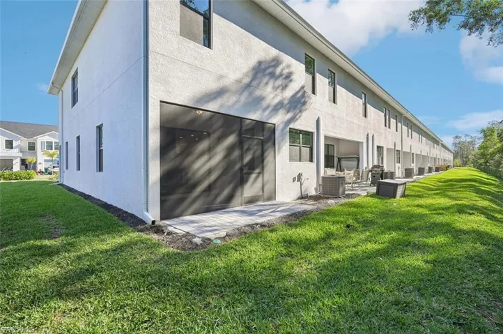 Model Home Virtually staged Back of house with a yard, a patio area, and stucco siding