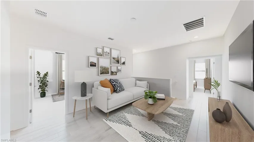 Model Home Virtually staged Living area featuring light wood-style floors and recessed lighting