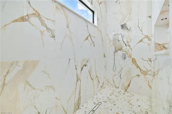Bathroom view of a marble finish shower