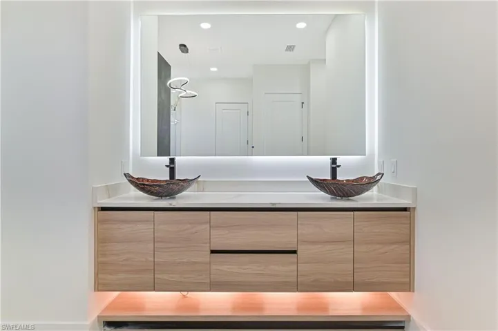 Full bathroom featuring double vanity and recessed lighting