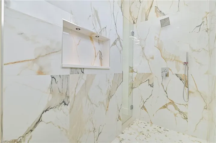 Bathroom featuring a marble finish shower