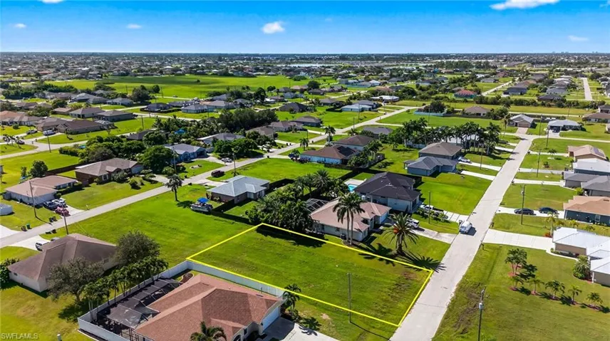 Aerial view of residential area featuring property boundaries highlighted