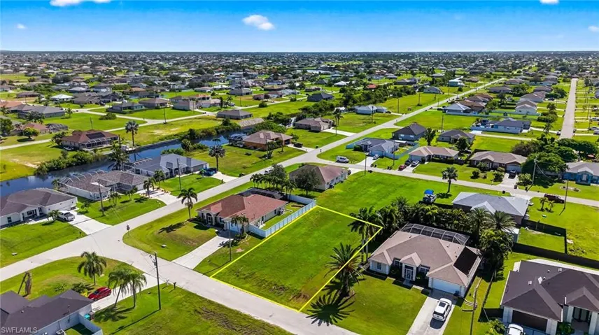 Aerial perspective of suburban area featuring a nearby body of water
