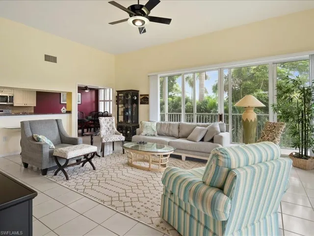 Living room featuring light tile patterned floors and a ceiling fan