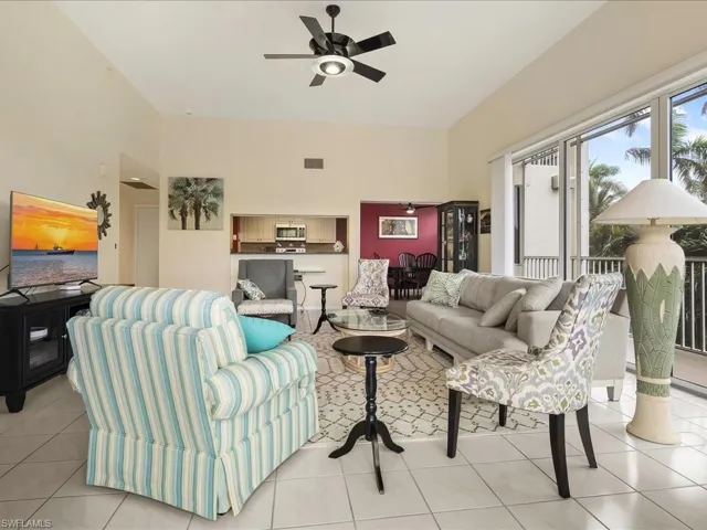 Living area with light tile patterned floors and ceiling fan