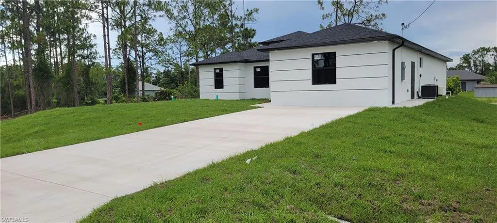 Prairie-style home with a yard and driveway
