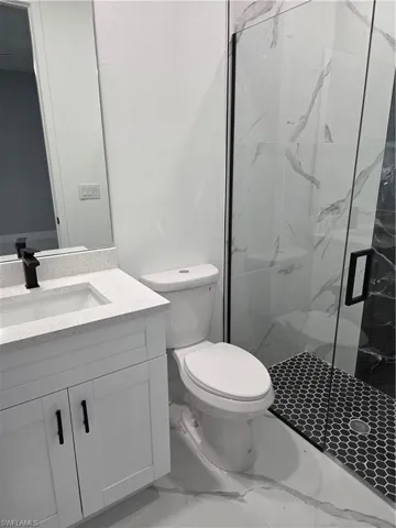Laundry area with hookup for an electric dryer, washer hookup, and marble look tile flooring