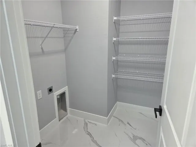 Unfurnished bedroom featuring a closet, a ceiling fan, and light marble finish flooring