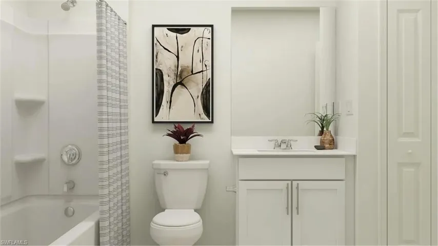 Bathroom featuring a white vanity with integrated sink, chrome faucet, and a large wall-mounted mirror
