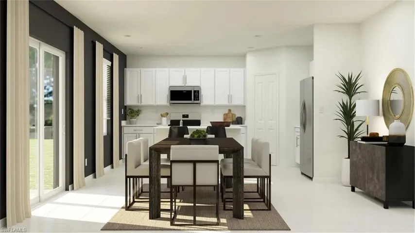 Open concept living space featuring a modern kitchen, dining area, and patio access