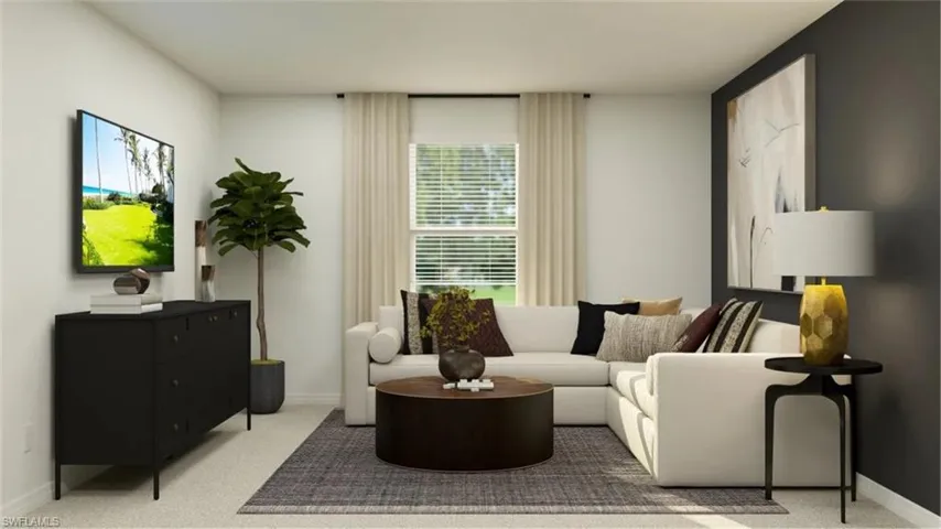 Bright living space with neutral wall tones and carpeted flooring