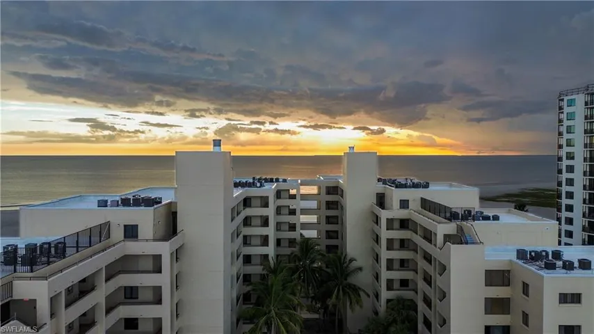 Property at dusk featuring a view of apartment building / complex and a water view