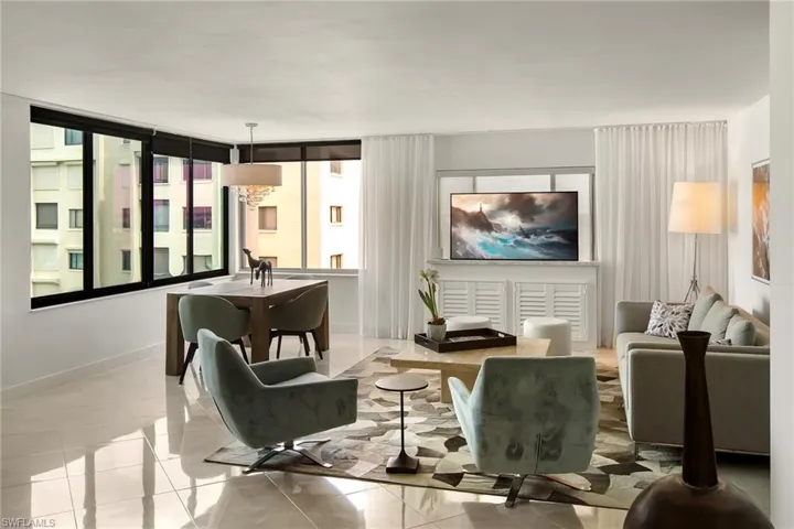 Tiled living area featuring a chandelier