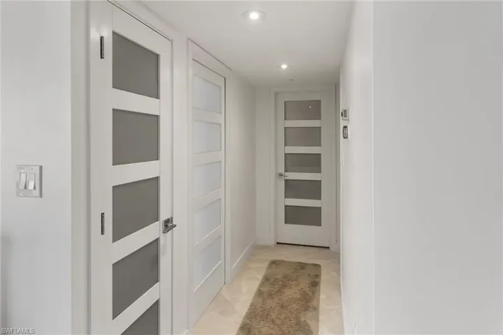 Corridor featuring recessed lighting and light tile patterned floors