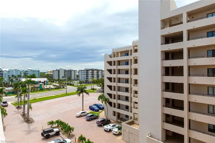 View of building exterior with view of water and beach