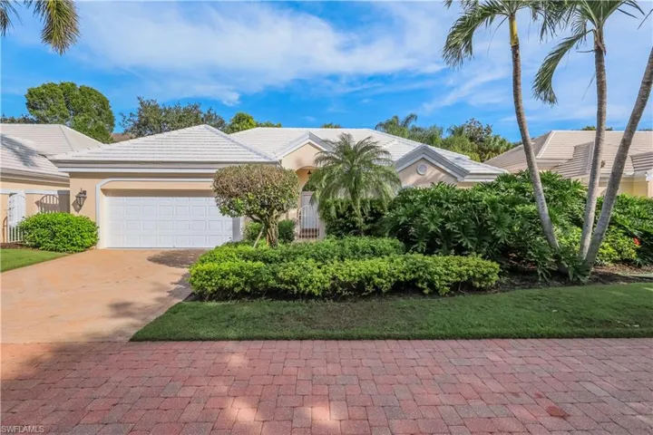 Exterior featuring a stucco finish, tile roof, attached garage, and mature landscaping