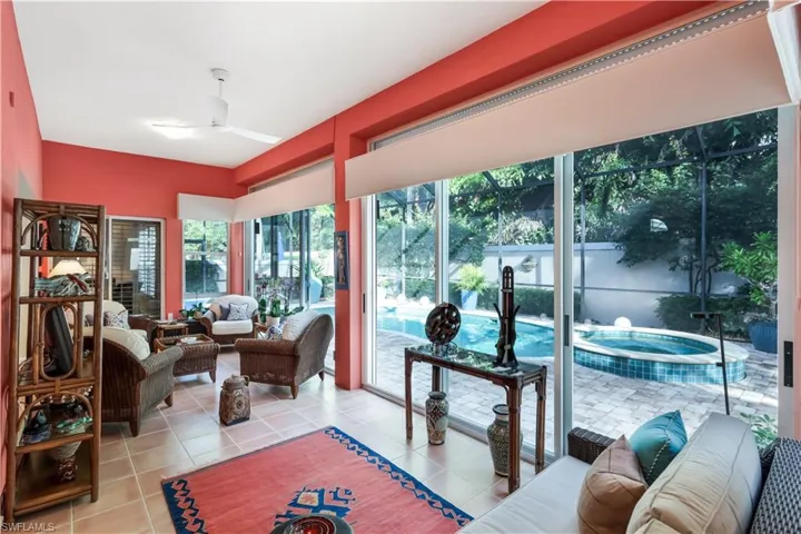 Expansive tiled flooring throughout, with a ceiling fan and recessed lighting