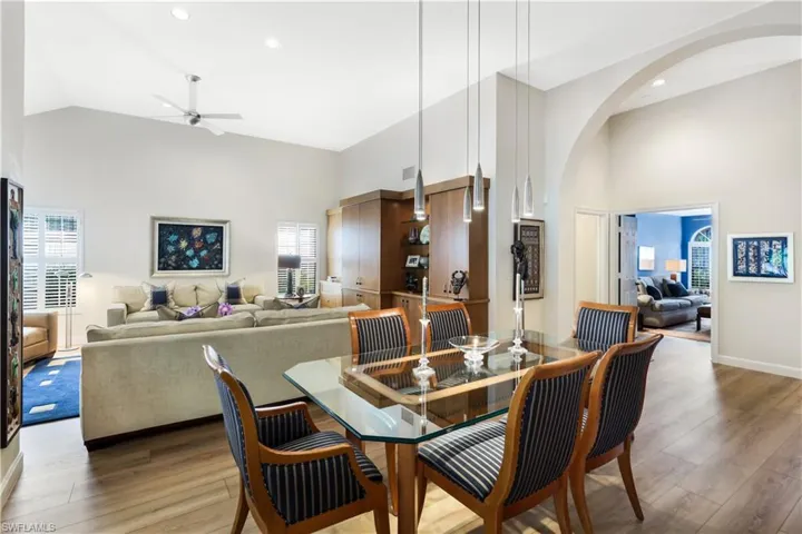 Vaulted ceilings, wood-finish flooring, built-in cabinetry, and recessed lighting