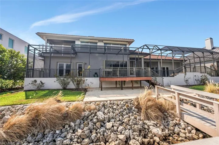 Rear view of house featuring a lanai