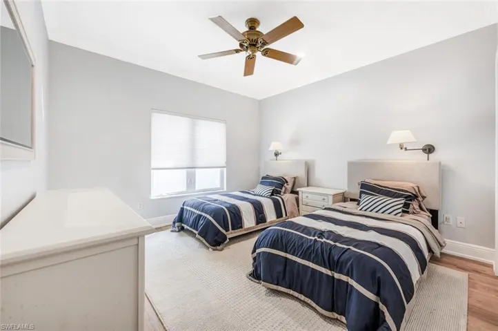 Bedroom with light hardwood / wood-style floors and ceiling fan