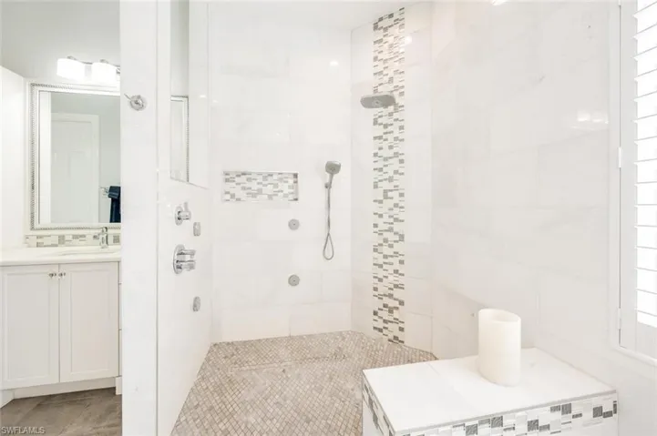 Bathroom with a tile shower and vanity