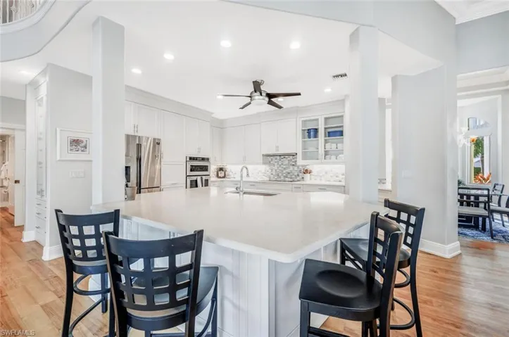 Kitchen featuring sink, light hardwood / wood-style flooring, stainless steel appliances, and white cabinets