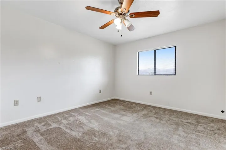 Spare room featuring ceiling fan and carpet floors
