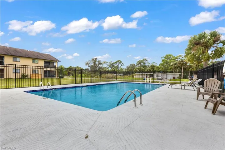 View of swimming pool featuring a patio area and a lawn