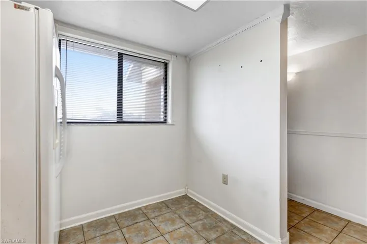 Empty room with light tile patterned floors