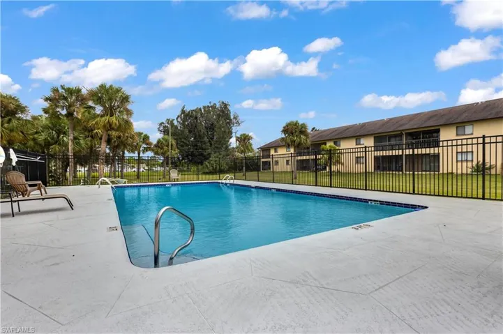 View of swimming pool with a yard and a patio area