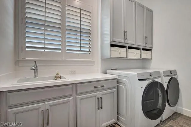 Laundry room featuring washer and dryer, porcelain would like tile  floors.