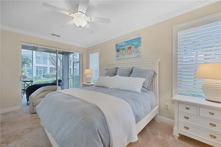 Bedroom with crown molding, access to outside, ceiling fan, and light colored carpet
