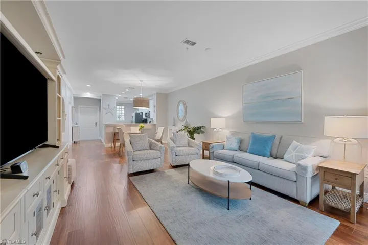 Living area featuring crown molding and wood-type flooring