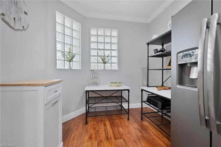 Office space featuring ornamental molding and wood finished floors